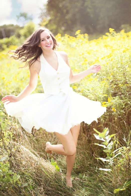 a woman in a white dress running through a field, dslr photo of a pretty teen girl, kailee mandel, 🌸 🌼 💮, smiling and dancing