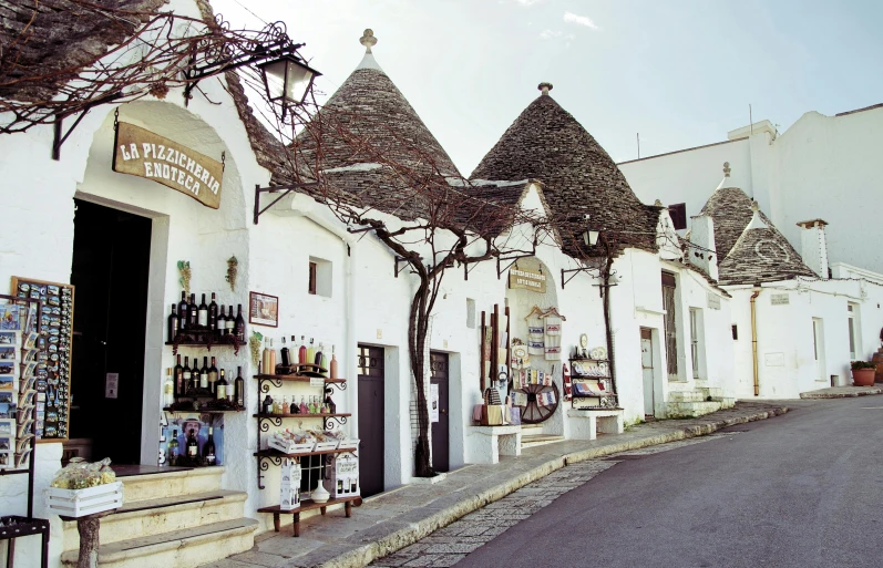 a couple of buildings that are next to each other, inspired by Serafino De Tivoli, pexels contest winner, renaissance, bottles covered in wax, white wall complex, trulli, streetscape