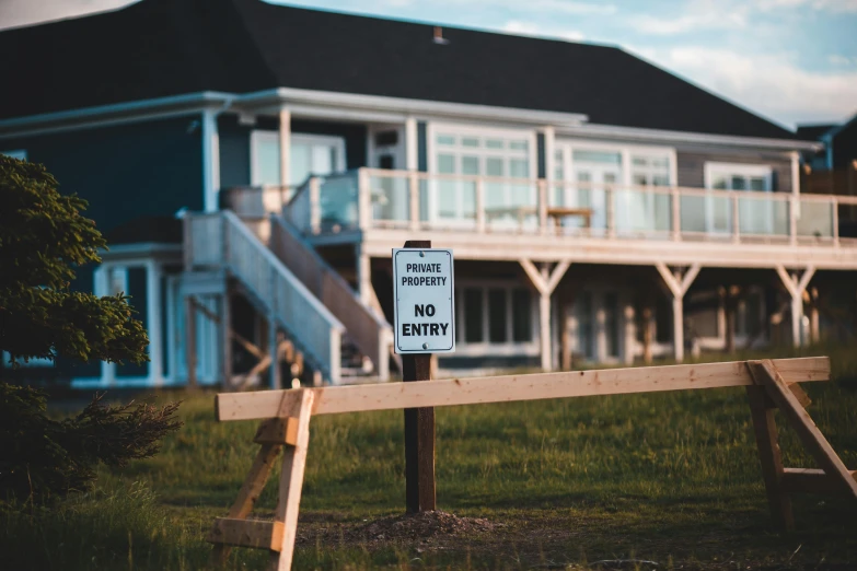 a no parking sign in front of a house, pexels contest winner, lake house, casually dressed, fences, hardmesh post