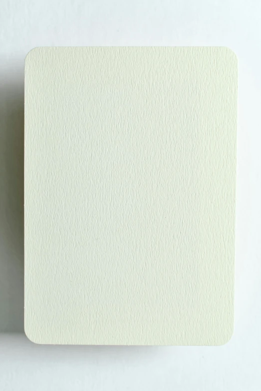 a piece of white paper sitting on top of a table, a minimalist painting, inspired by Rachel Whiteread, unsplash, very dull colors, cream white background, very realistic. low dark light, koji morimoto