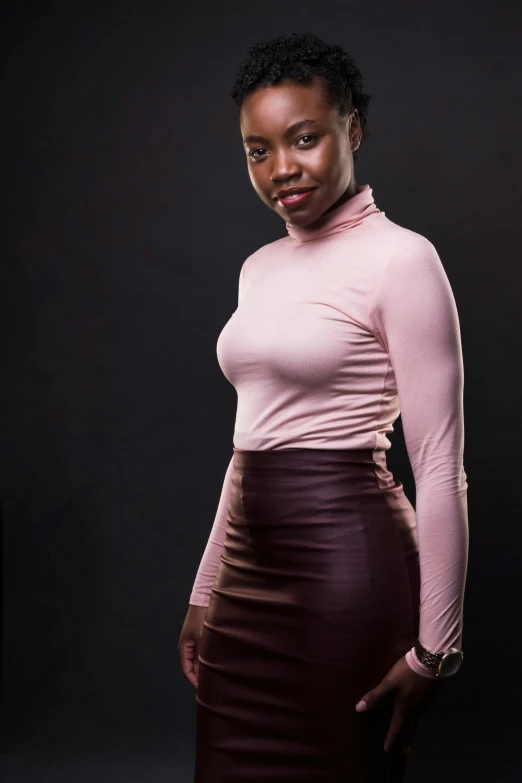 a woman in a pink top and brown skirt, by Chinwe Chukwuogo-Roy, pexels contest winner, renaissance, wearing turtleneck, leather body suit, ( ( dark skin ) ), light skin