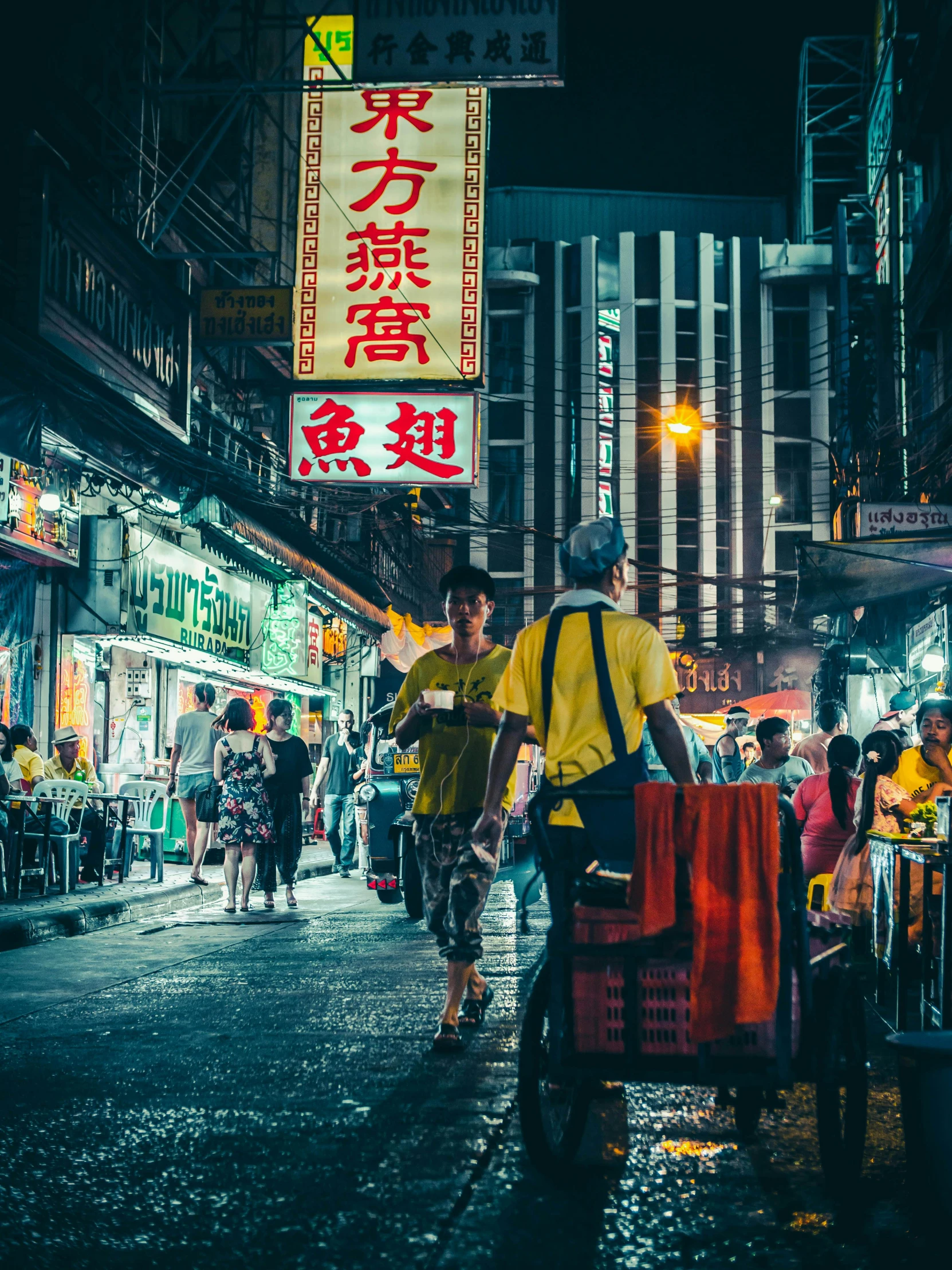 a man riding a bike down a street at night, by Patrick Ching, pexels contest winner, graffiti, people outside eating meals, traditional chinese clothing, cyberpunk signs, travelers walking the streets