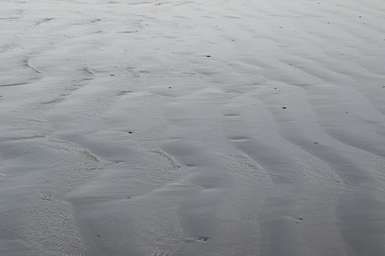 a red fire hydrant sitting on top of a sandy beach, inspired by Vija Celmins, lyrical abstraction, grey, ((waves, lena oxton, photography ultrafine detail