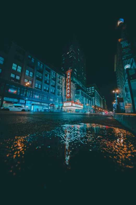 a city street filled with lots of traffic at night, by Greg Rutkowski, unsplash contest winner, reflection puddles, epic theater, marquee, chicago