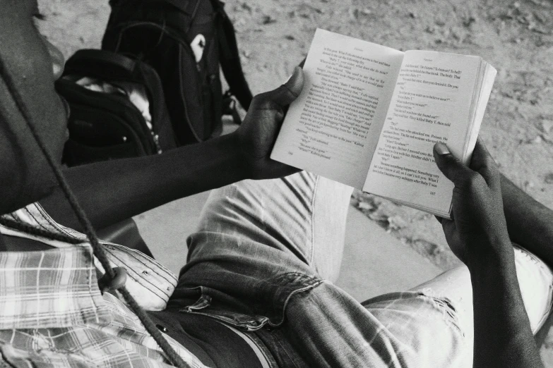 a black and white photo of a man reading a book, by Romain brook, kano), book in hand, student, rj palmer