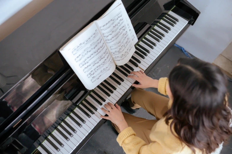 a close up of a person playing a piano, ariel view, for junior, gemma chen, islamic