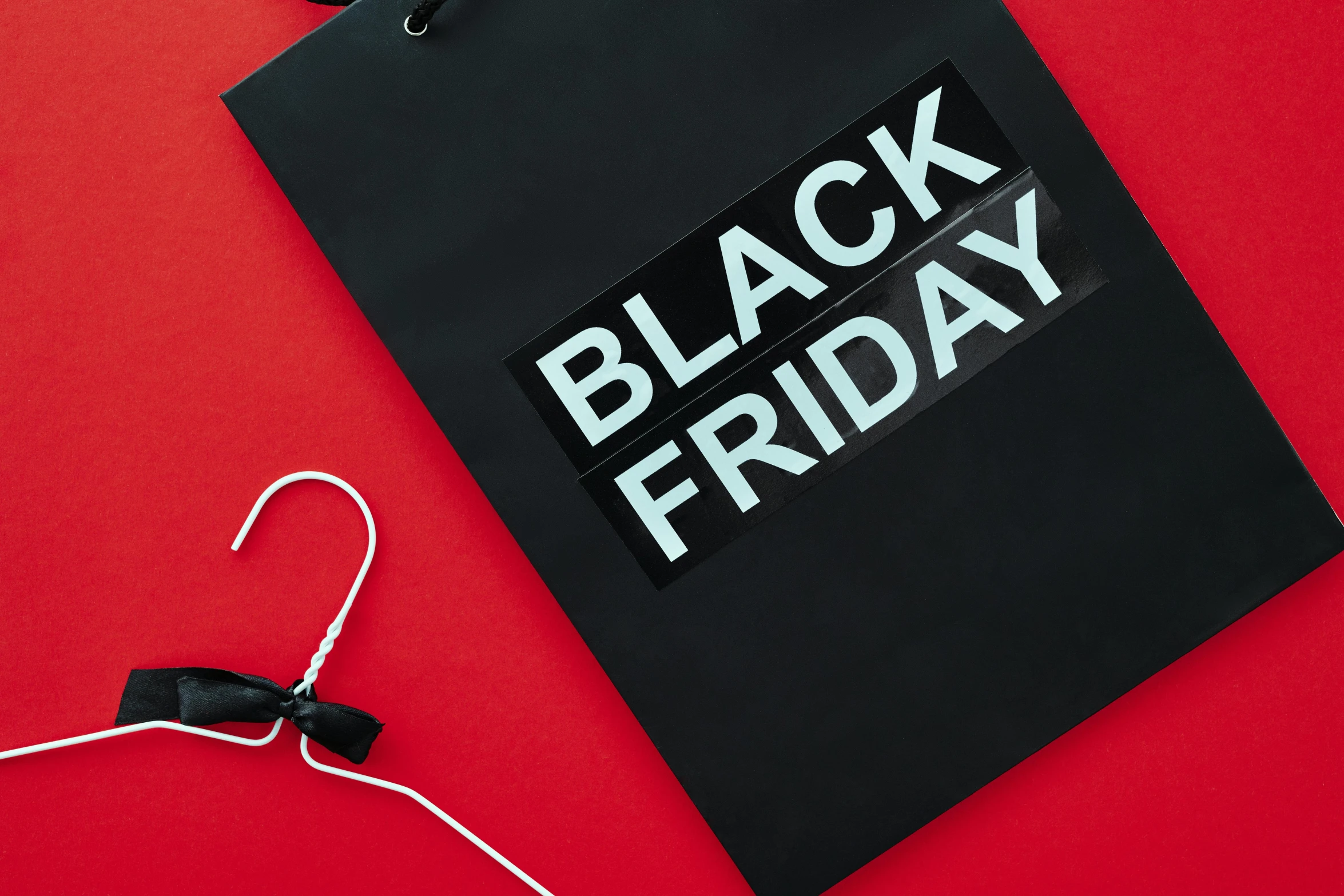 a black friday shopping bag on a red background, by Julia Pishtar, hurufiyya, matte black paper, instagram story, holiday, blackboard