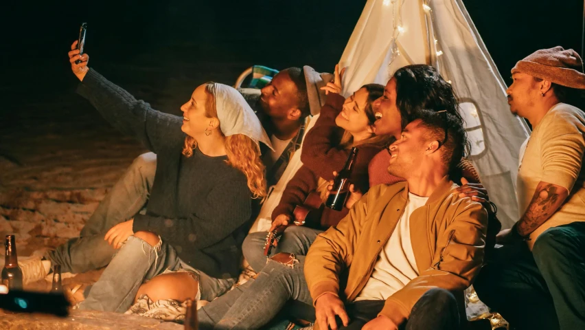 a group of people sitting around a campfire, trending on pexels, renaissance, taking a selfie, tickle fight in the death tent, rooftop romantic, profile image