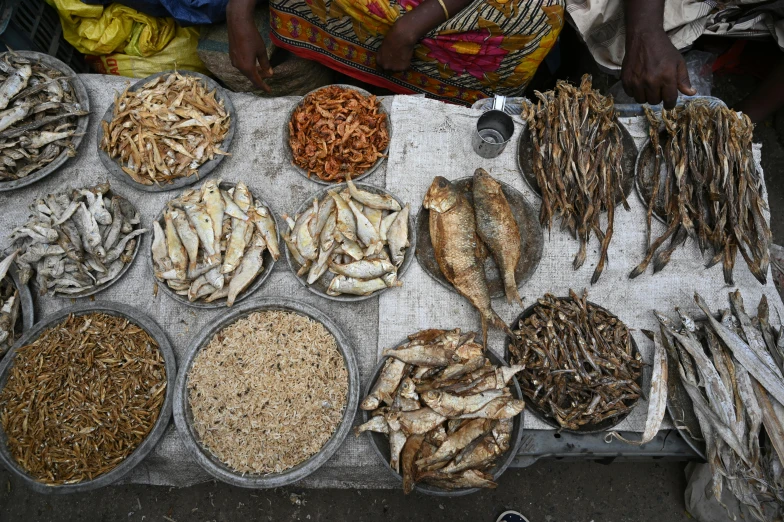 a table topped with lots of different types of fish, by Ingrida Kadaka, hurufiyya, 2022 photograph, spices, thumbnail