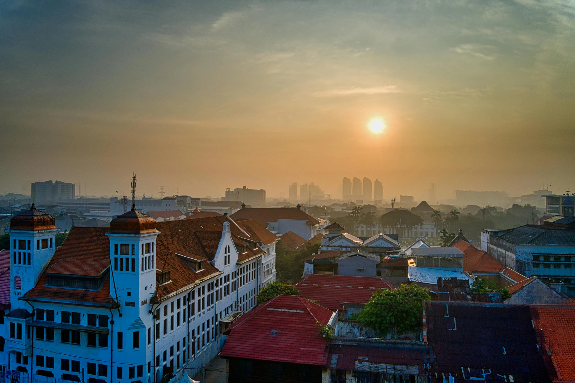 a view of a city from the top of a building, pexels contest winner, sumatraism, sun at dawn, white buildings, old town, postprocessed