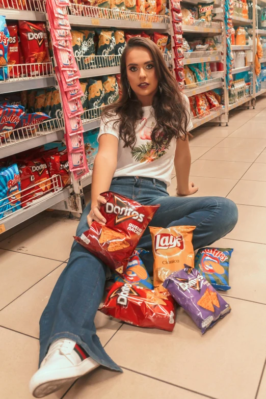 a woman sitting on the floor in a grocery store, by Gina Pellón, pexels contest winner, pop art, crisps, female camila mendes, nachos, instagram photo shoot