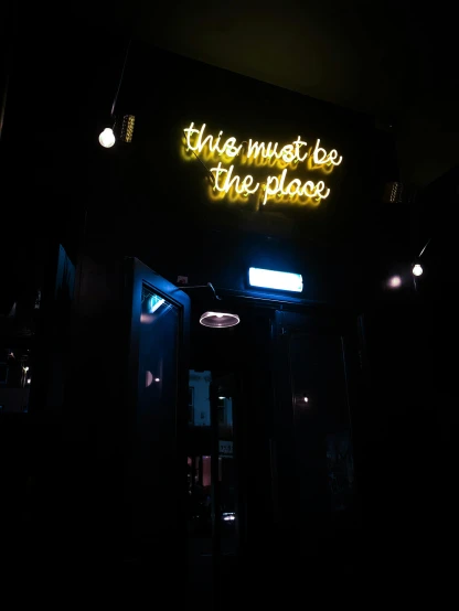 a neon sign that says this must be the place, by Robbie Trevino, trending on unsplash, cozy dark 1920s speakeasy bar, 💋 💄 👠 👗, thumbnail, the backrooms liminal space