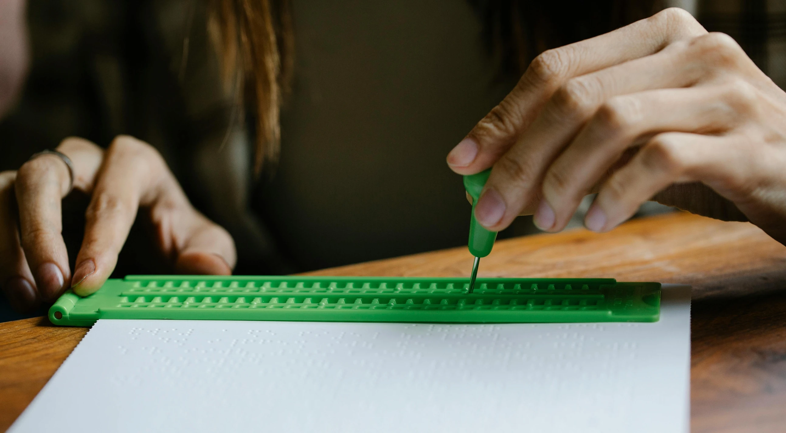 a close up of a person using a ruler on a piece of paper, pexels contest winner, interactive art, green, legos, dot painting, indi creates