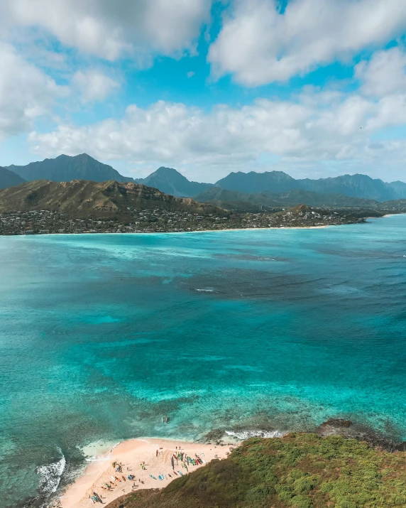 a large body of water next to a lush green hillside, a photo, pexels contest winner, hurufiyya, waikiki beach, crystal clear blue water, thumbnail, dessert