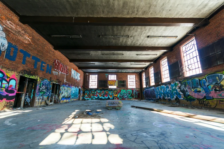 a large room with lots of graffiti on the walls, unsplash, graffiti, collapsed floors, thumbnail, sun shining, russ mill