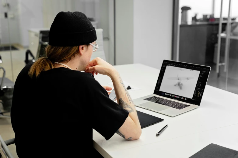 a person sitting at a table with a laptop, a drawing, inspired by Jakob Gauermann, digital sculpture, lachlan bailey, looking across the shoulder, inked digital