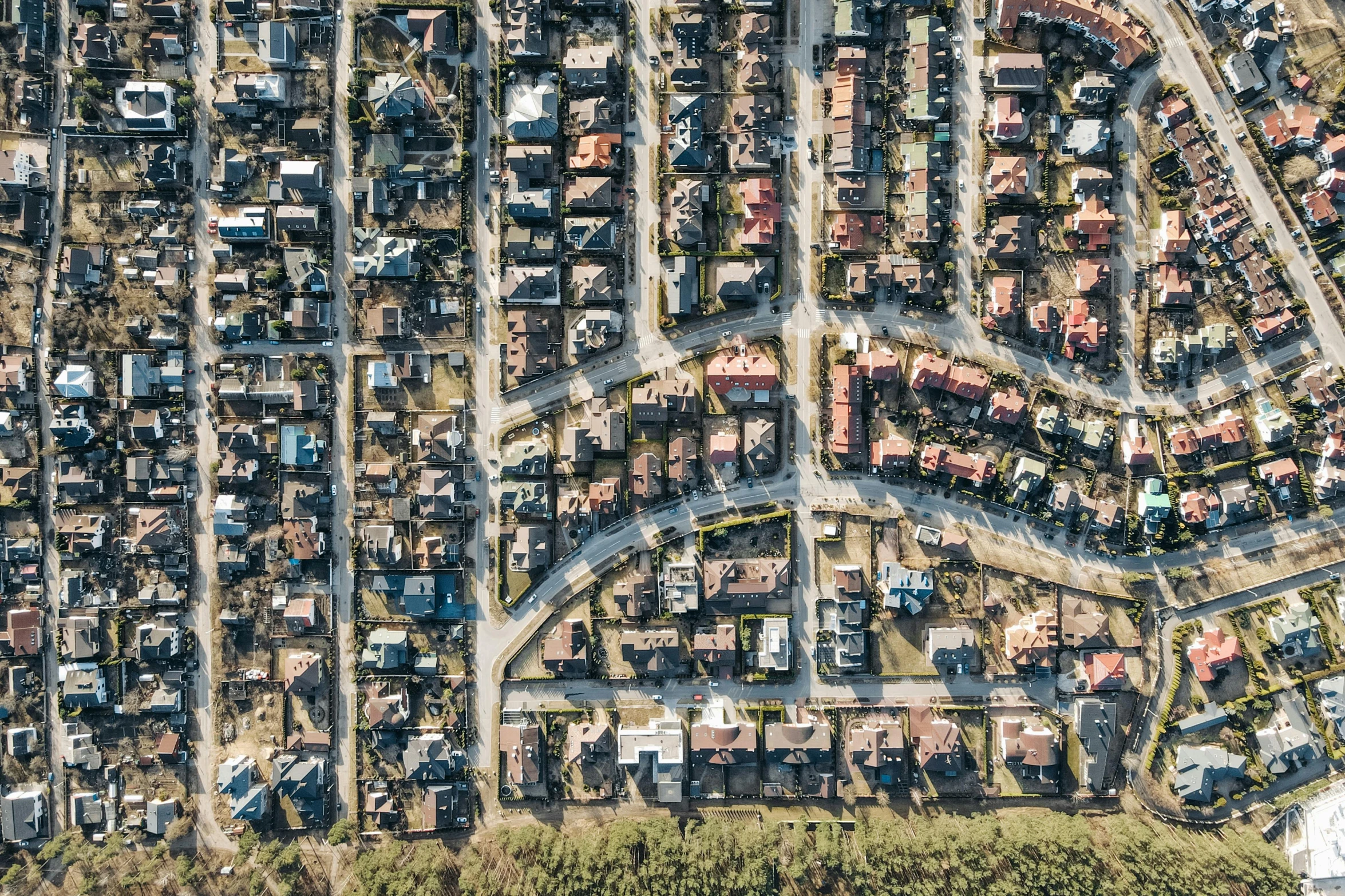 an aerial view of a city with lots of houses, by Carey Morris, pexels, photorealism, abandoned streets, suburban neighborhood, high resolution details, facing sideways