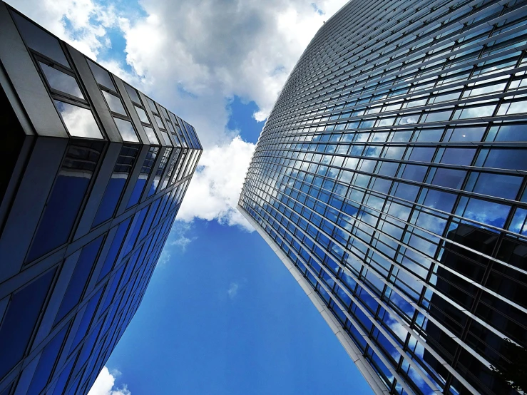 a couple of tall buildings next to each other, by Jan Rustem, pexels contest winner, glass ceilings, under blue clouds, thumbnail, hyperdetailed!