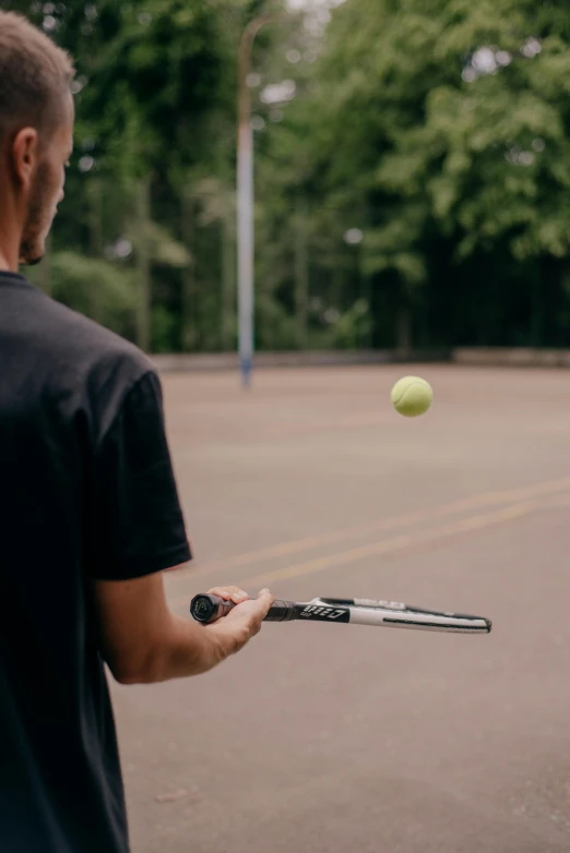 a man hitting a tennis ball with a racquet, unsplash, holding a shotgun, rectangle, low quality photo, extended clip