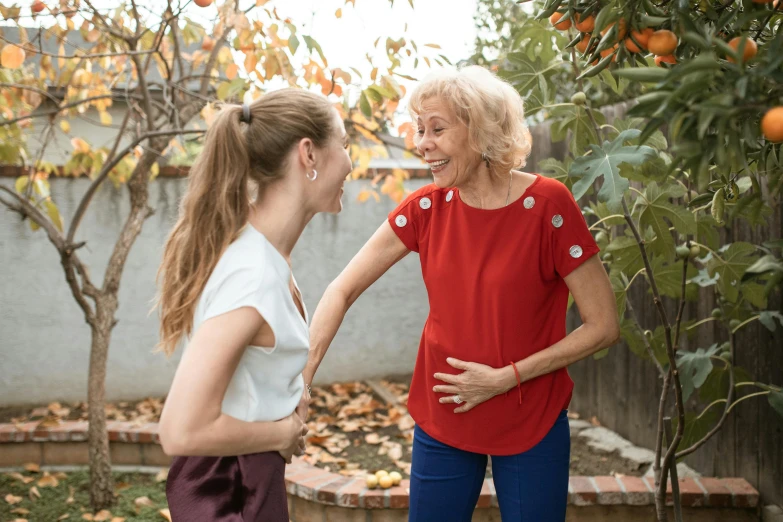 a woman standing next to a woman in a yard, pexels contest winner, happening, earing a shirt laughing, an old lady with red skin, 15081959 21121991 01012000 4k, tall and lanky skinny