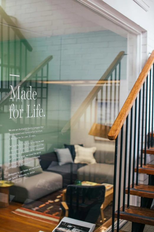 a living room filled with furniture next to a staircase, poster art, by Alice Mason, trending on unsplash, made of glass, shop front, healthcare, of life the beginning