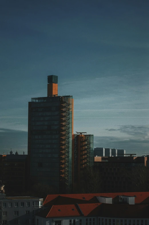 a group of tall buildings sitting next to each other, by Sebastian Spreng, pexels contest winner, modernism, evening light, sunfaded, swedish urban landscape, brutalist buildings tower over