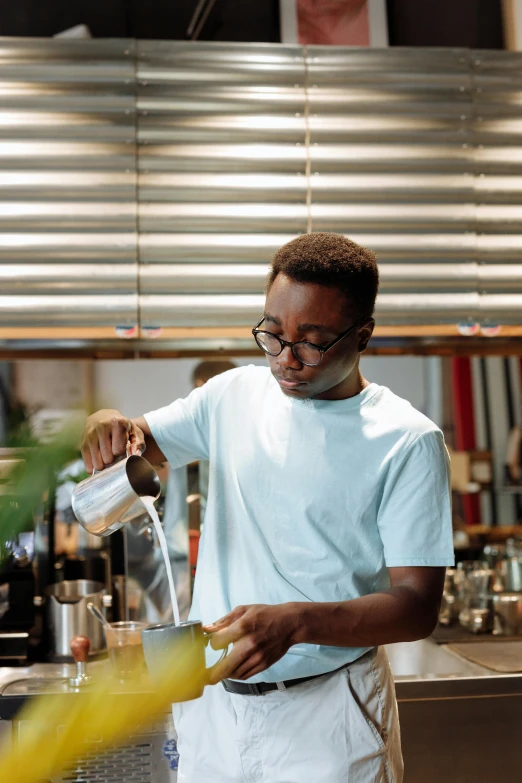 a man pouring something into a glass in a kitchen, inspired by Barthélemy Menn, trending on unsplash, ethiopian, square, android coffee shop, kara walker james jean