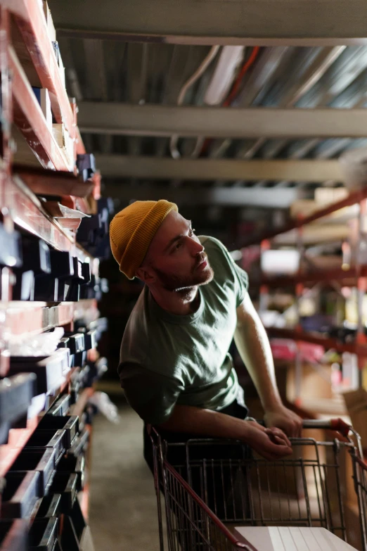 a man pushing a shopping cart through a store, a portrait, pexels, renaissance, worksafe. instagram photo, contemplating, in a warehouse, lachlan bailey