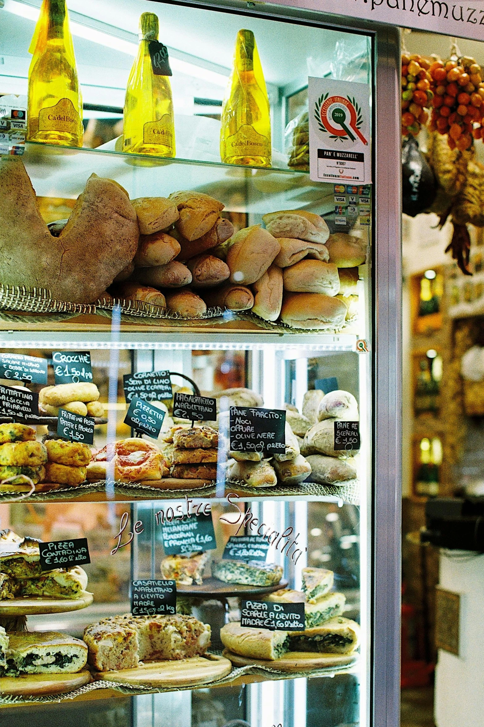 a display case filled with lots of different types of pastries, by Antonio Saura, renaissance, fish seafood markets, seen from outside, with bread in the slots, teaser