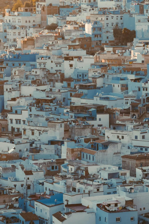 a view of a city from the top of a hill, inspired by Alberto Morrocco, warm shades of blue, large scale photo, moroccan, terraced