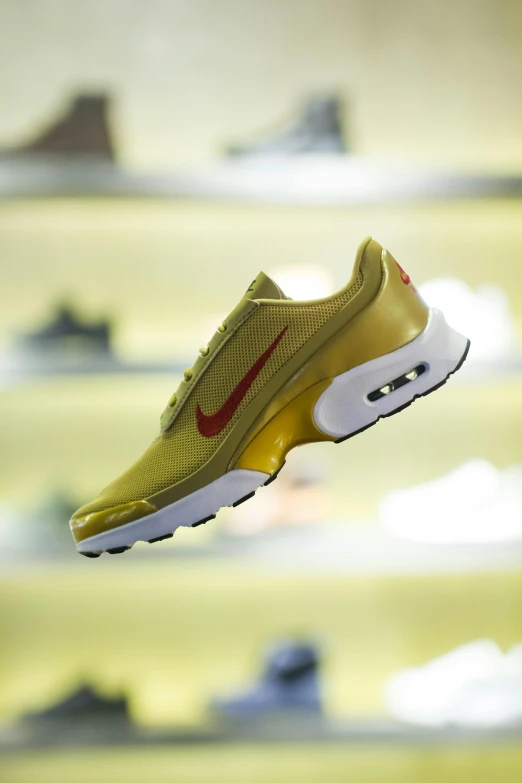 a person holding a pair of shoes in a shoe store, a digital rendering, featured on instagram, gold and red, nike air max, side view close up of a gaunt, hovering in the air