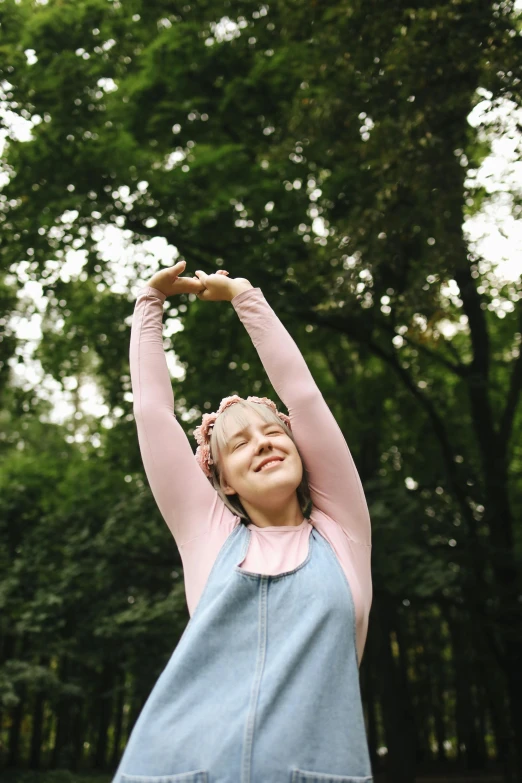 a woman reaching up to catch a frisbee, by Attila Meszlenyi, pexels, renaissance, wearing a pink head band, pose(arms up + happy), person made of tree, a blond