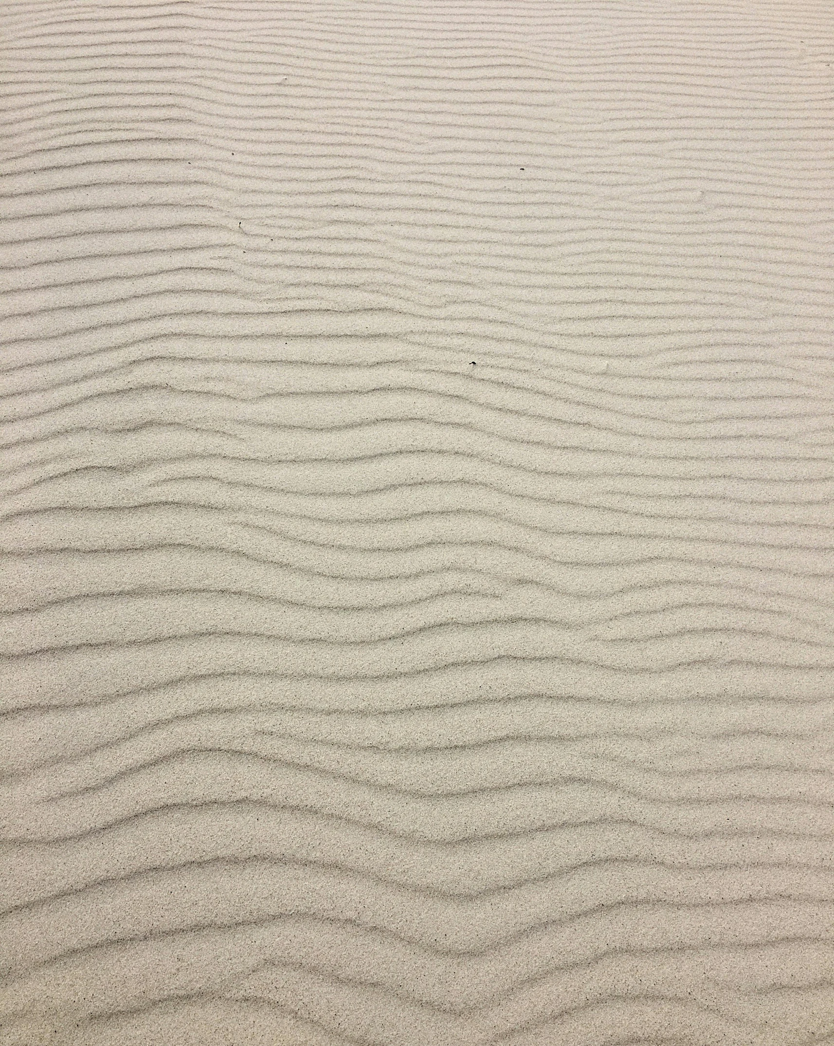 waves in the sand on a beach, an album cover, inspired by Edward Weston, highly detailed # no filter, very pale, tan, concrete