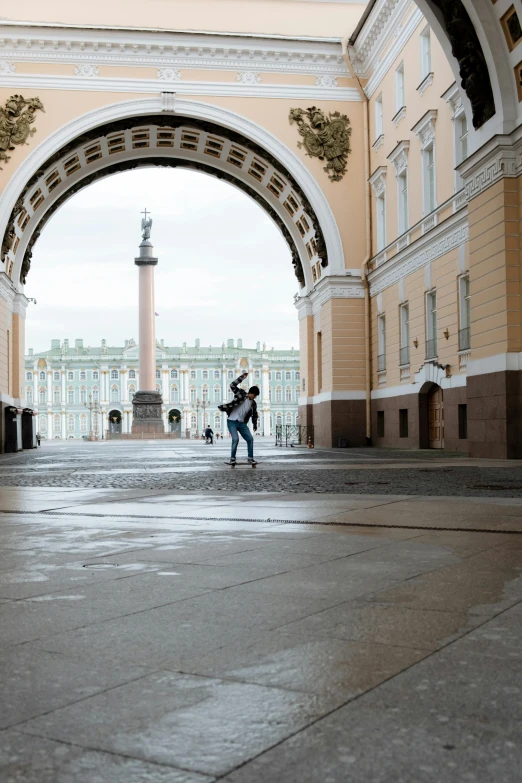 a man riding a skateboard on top of a cement floor, a picture, inspired by Illarion Pryanishnikov, pexels contest winner, neoclassicism, couple kissing, an archway, kremlin, palace background