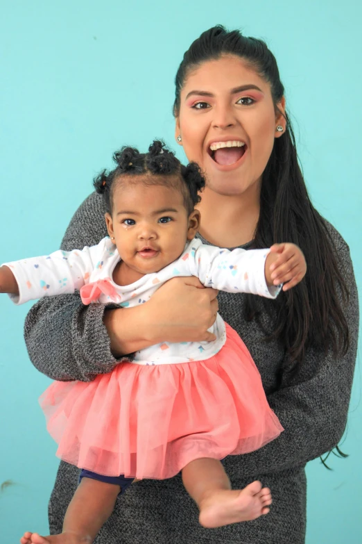a woman holding a baby in her arms, shutterstock contest winner, happening, modeling for dulce and gabanna, mixed race, full screen, twirly