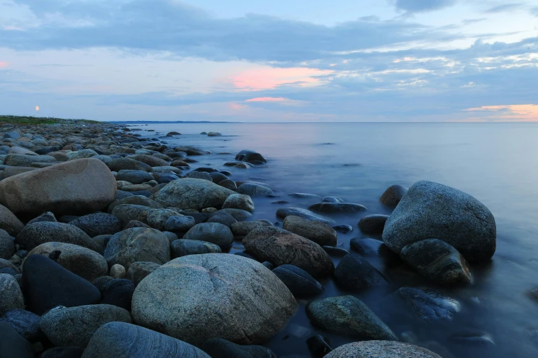 a group of rocks sitting on top of a rocky beach, by Jesper Knudsen, unsplash, calm evening, 2 5 6 x 2 5 6 pixels, harbor, hestiasula head