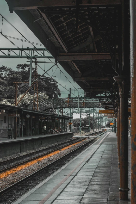 a train station with a train on the tracks, unsplash contest winner, hyperrealism, south jakarta, instagram story, japanese town, gloomy colors