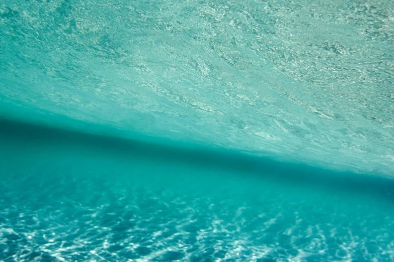 a man riding a wave on top of a surfboard, unsplash, minimalism, underwater soft colours, glistening seafoam, middle close up, cerulean