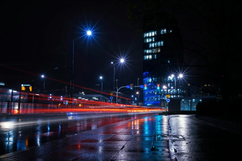 a city street filled with lots of traffic at night, by Sebastian Spreng, unsplash contest winner, realism, hannover, brutalist city, it is night and raining, blue and orange rim lights