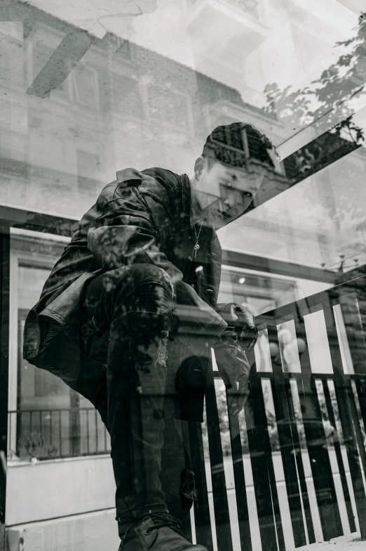 a black and white photo of a man sitting on a fence, inspired by Louis Stettner, pexels contest winner, realism, reflections on a glass table, james jean and yoji shinkawa, glitch effect, shopwindows