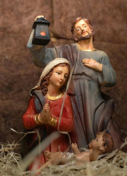 a figurine of jesus and mary in a manger, a statue, by Jan Tengnagel, pexels, figuration libre, kneeling and looking up, roman catholic icon, drinking, lights