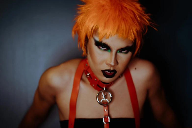 a close up of a person with an orange hair, an album cover, inspired by James Bolivar Manson, transgressive art, black leather harness, an epic non - binary model, official photo, tonic the fox