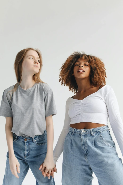 a couple of women standing next to each other, trending on pexels, renaissance, wearing a cropped tops, young woman looking up, wearing pants and a t-shirt, light clothing