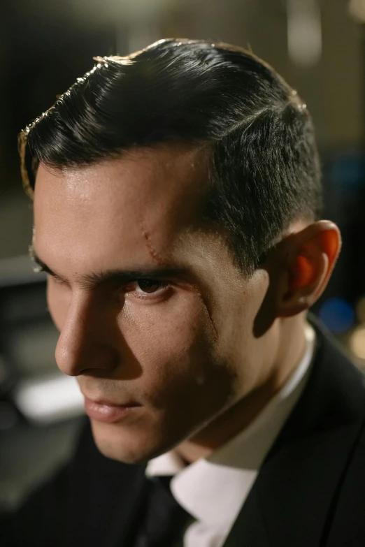 a close up of a person wearing a suit and tie, by Alejandro Obregón, reddit, serial art, prosthetic makeup, handsome male vampire, production still, david marquez