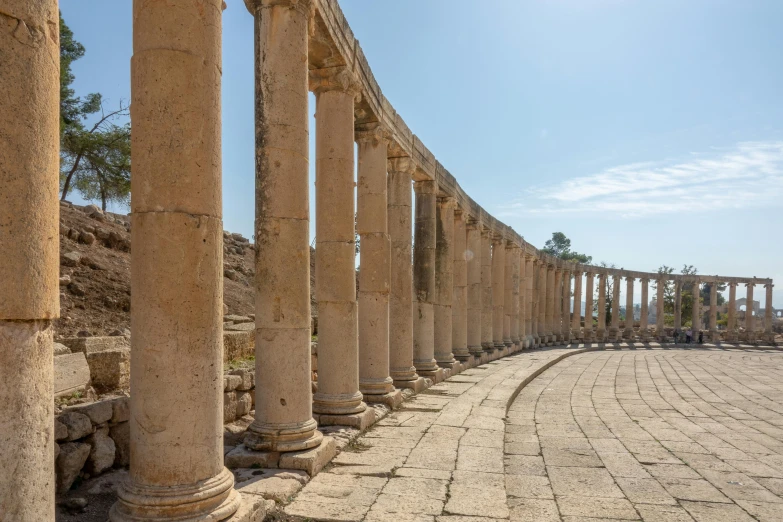 a row of columns on the side of a road, an album cover, pexels contest winner, neoclassicism, israel, sportspalast amphitheatre, white travertine terraces, pink arches