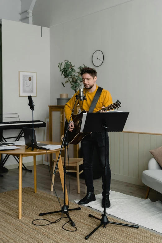 a man playing a guitar and singing into a microphone, an album cover, by Hallsteinn Sigurðsson, pexels, romanticism, in a living room, 15081959 21121991 01012000 4k, casually dressed, liam