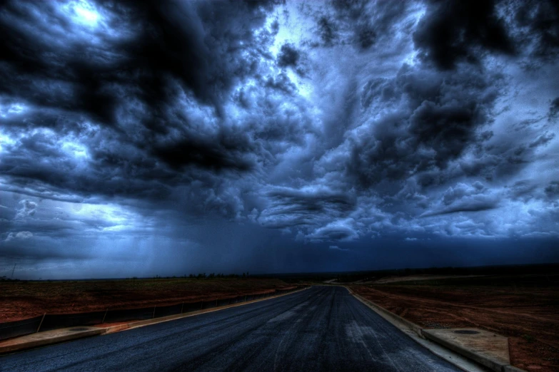 a road in the middle of a field under a cloudy sky, pexels contest winner, surrealism, ominous nighttime storm, blue storm clouds, toxic clouds, imgur