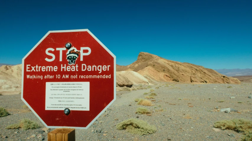 a red stop sign sitting in the middle of a desert, pexels contest winner, graffiti, hot temperature, slate, black, geology