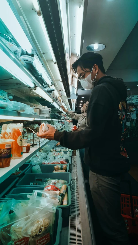 a man wearing a face mask in a grocery store, pexels, hyperrealism, square, underlit, shelf, eating