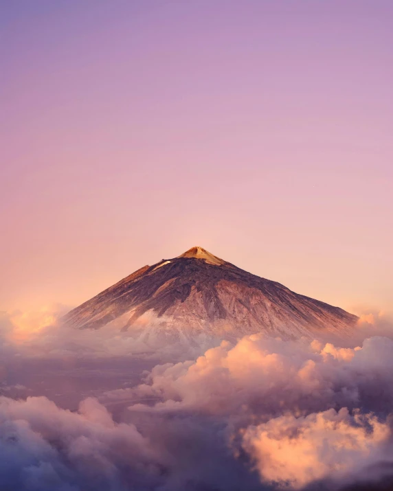 a mountain surrounded by clouds in the sky, by Julia Pishtar, volcano background, pink skies, top selection on unsplash, 🚿🗝📝